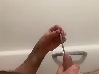 A guy indulges in self-pleasure, inserting a penis plug into his manhood. The video captures his intense reactions as he stimulates himself with the foreign object.