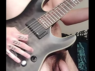 Steady on the six-string and self-pleasure, this rocker showcases his tattooed manhood. Halloween cosplay adds a twist to this solo performance. Alien girl joins for a spanking, elevating the eroticism of this Prague-set, geeky guitar masturbation.